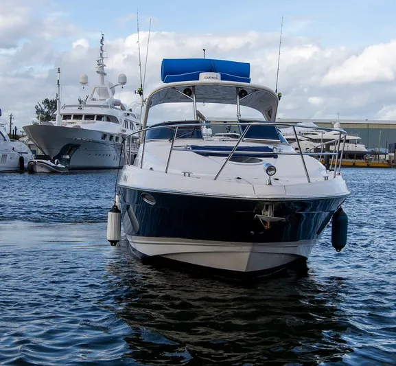  Yacht Photos Pics 2008 Regal 38 boat docked in marina, surrounded by other yachts under cloudy sky.