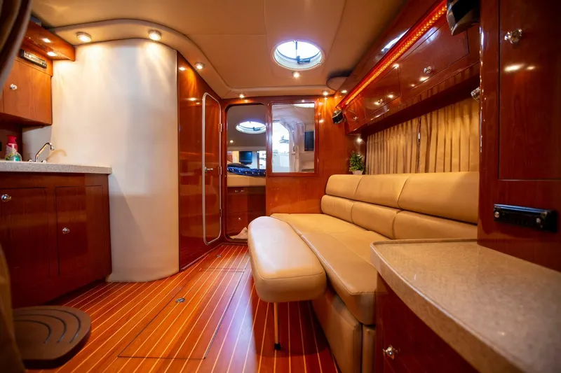  Yacht Photos Pics Luxurious interior of a 2008 Regal 38 yacht with elegant wood finishes and plush seating.