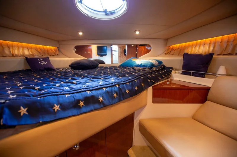  Yacht Photos Pics Luxurious 2008 Regal 38 yacht cabin with star-patterned bedding and cozy seating.