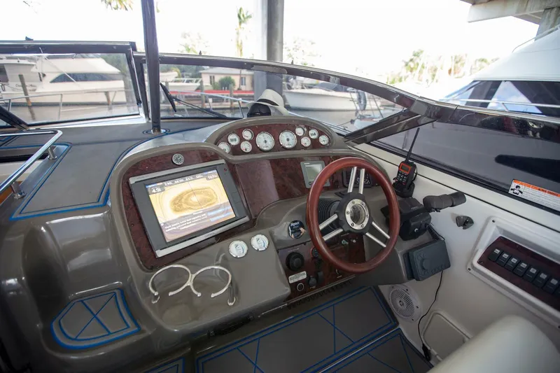 Yacht Photos Pics 2008 Regal 38 boat dashboard with steering wheel, gauges, and navigation screen.