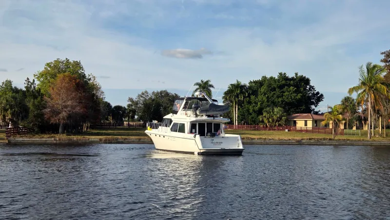 Toes In The Water Yacht Photos Pics 1998 Navigator 5300 yacht on calm water with tropical backdrop.