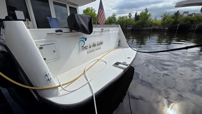 Toes In The Water Yacht Photos Pics Stern of a 1998 Navigator 5300 boat by the water.