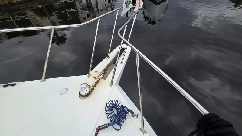 Toes In The Water Yacht Photos Pics Deck of a 1998 Navigator 5300 boat with railing and rope.