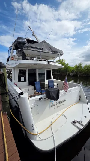Toes In The Water Yacht Photos Pics 1998 Navigator 5300 yacht docked with blue chairs.