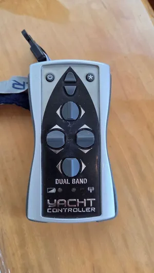 Toes In The Water Yacht Photos Pics Yacht controller with dual band feature on wooden table.