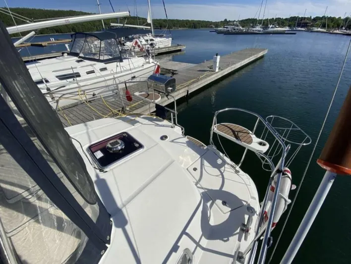  Yacht Photos Pics 2006 Hunter 45 Center Cockpit sailboat docked at a marina, sunny day, calm waters.