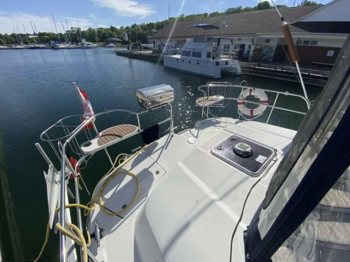  Yacht Photos Pics Hunter 45 Center Cockpit sailboat, 2006 model, docked at marina with clear skies.