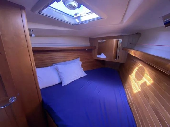  Yacht Photos Pics Cozy cabin interior of 2006 Hunter 45 Center Cockpit sailboat with blue bedding.