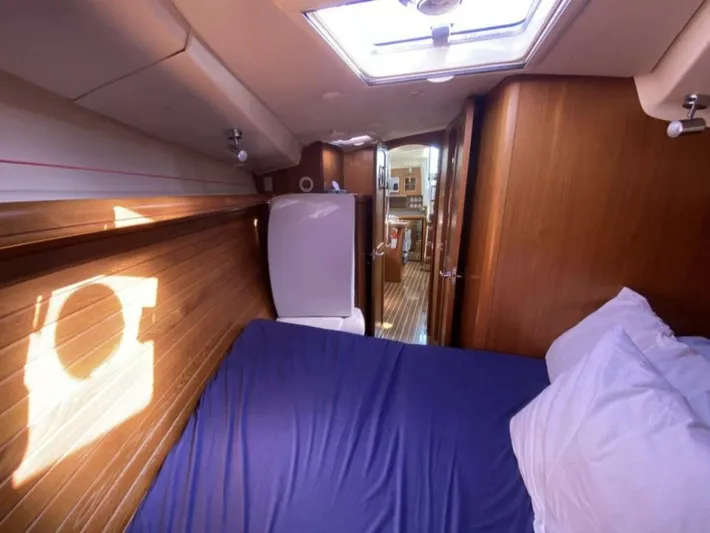  Yacht Photos Pics Interior of 2006 Hunter 45 Center Cockpit yacht with bed and wooden paneling.