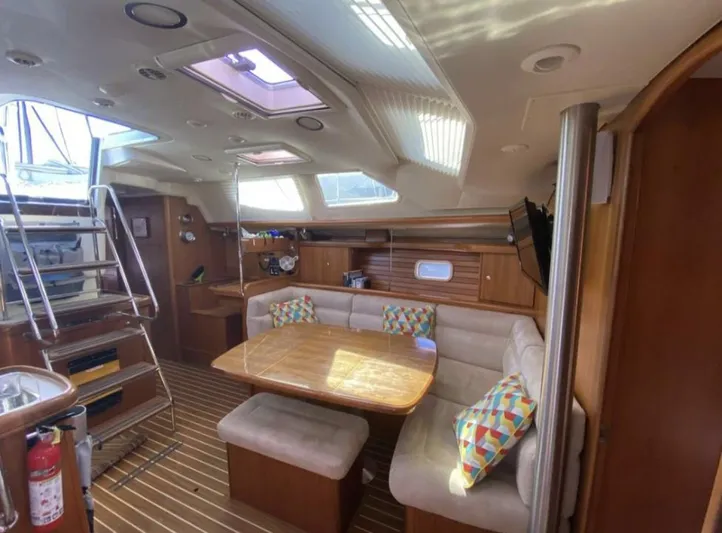  Yacht Photos Pics Interior of 2006 Hunter 45 Center Cockpit yacht with dining area and colorful cushions.