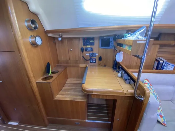  Yacht Photos Pics Interior of 2006 Hunter 45 Center Cockpit sailboat with navigation station and wooden cabinetry.