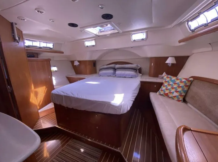  Yacht Photos Pics Luxurious cabin interior of 2006 Hunter 45 Center Cockpit yacht with cozy bed and seating.