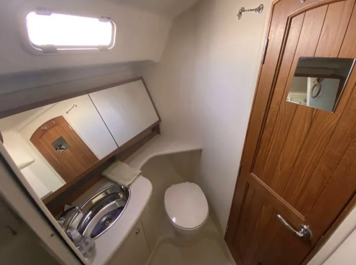  Yacht Photos Pics 2006 Hunter 45 Center Cockpit bathroom with sink, toilet, and wooden door.