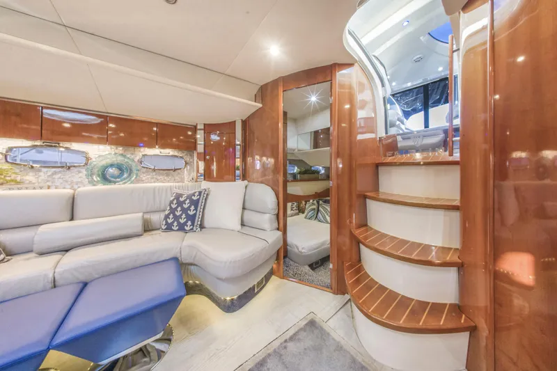 Just-us Yacht Photos Pics Luxurious interior of 2009 Fairline Targa 52 yacht with elegant seating and wooden staircase.