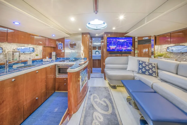 Just-us Yacht Photos Pics Luxurious interior of 2009 Fairline Targa 52 yacht with modern kitchen and seating area.