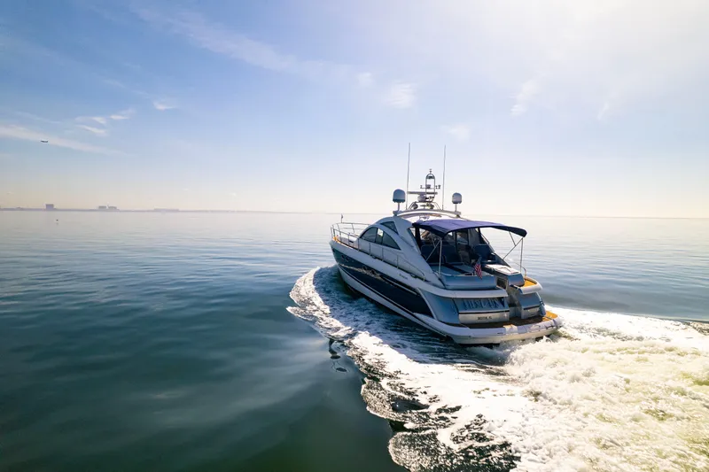 Just-us Yacht Photos Pics Luxury 2009 Fairline Targa 52 yacht cruising on calm ocean waters.