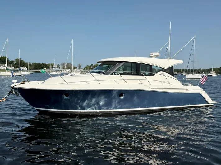 Silver Lining, Name Reserved Yacht Photos Pics 2017 Tiara Yachts 39 Coupe on water, sleek design, blue hull, anchored in marina.