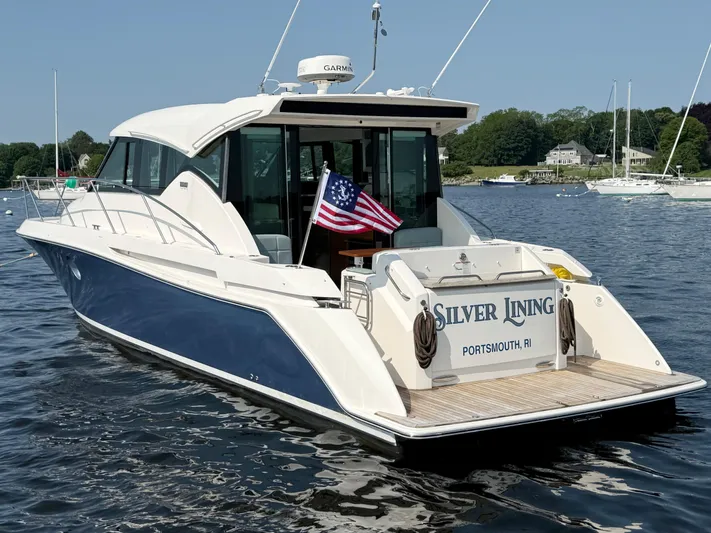 Silver Lining, Name Reserved Yacht Photos Pics 2017 Tiara Yachts 39 Coupe on water, displaying American flag, named "Silver Lining."
