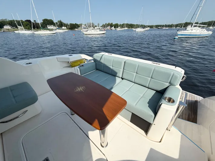 Silver Lining, Name Reserved Yacht Photos Pics 2017 Tiara Yachts 39 Coupe with elegant seating and table, overlooking a serene marina.