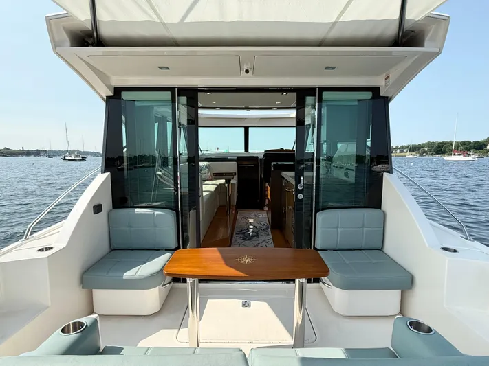 Silver Lining, Name Reserved Yacht Photos Pics 2017 Tiara Yachts 39 Coupe with open cockpit and seating, overlooking a serene waterfront.