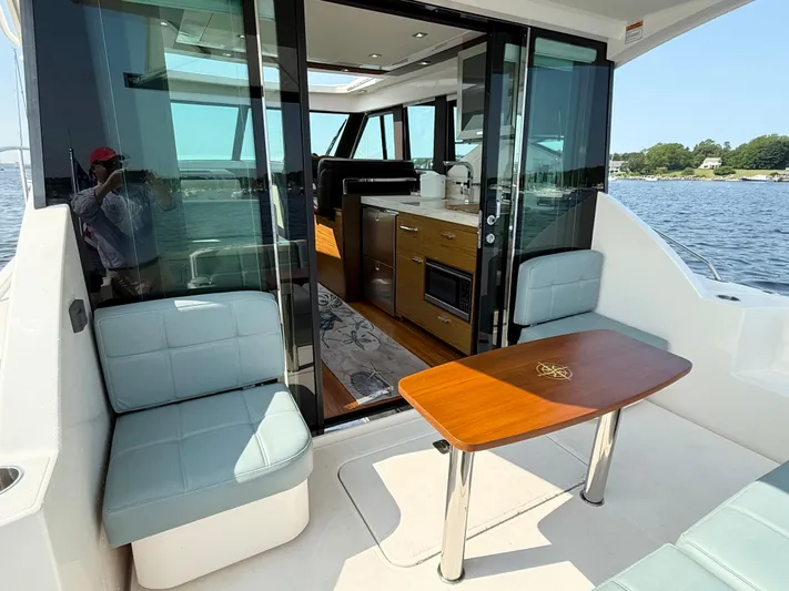 Silver Lining, Name Reserved Yacht Photos Pics 2017 Tiara Yachts 39 Coupe interior with seating and table, overlooking water.