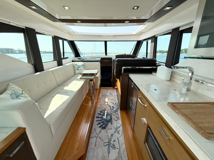 Silver Lining, Name Reserved Yacht Photos Pics Interior of 2017 Tiara Yachts 39 Coupe with modern kitchen and seating area.