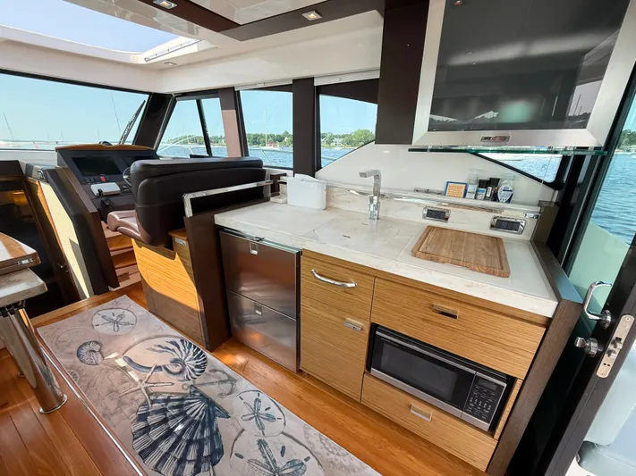 Silver Lining, Name Reserved Yacht Photos Pics Interior of 2017 Tiara Yachts 39 Coupe with modern kitchen and scenic window view.