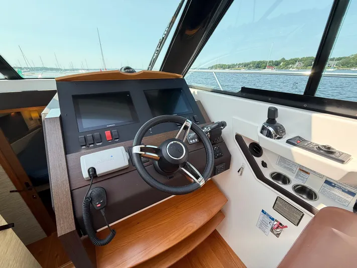 Silver Lining, Name Reserved Yacht Photos Pics Helm of 2017 Tiara Yachts 39 Coupe with steering wheel and navigation controls.