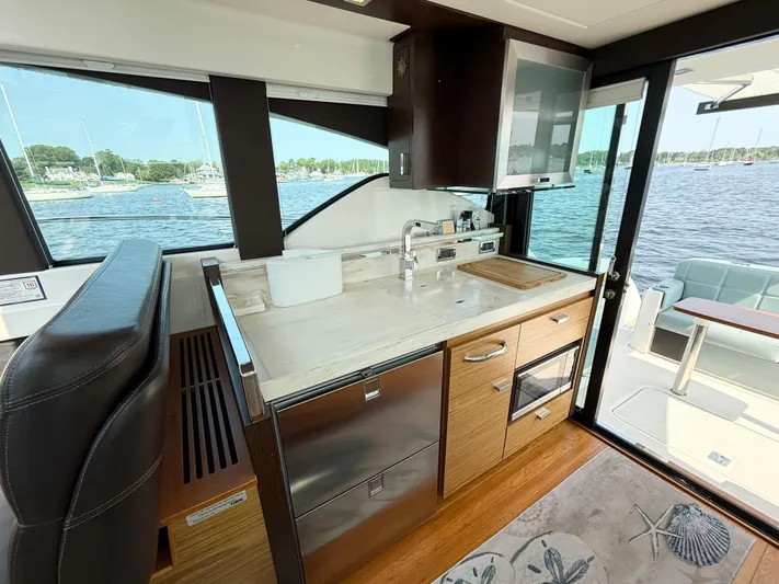 Silver Lining, Name Reserved Yacht Photos Pics Interior of 2017 Tiara Yachts 39 Coupe with modern kitchen and scenic water view.