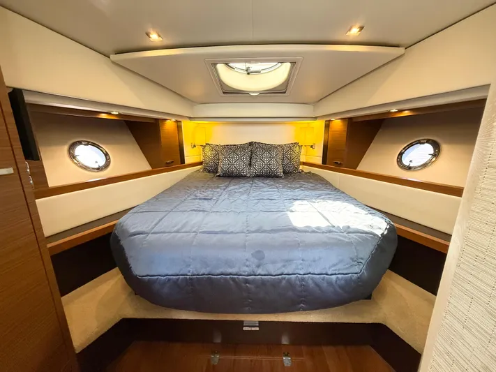 Silver Lining, Name Reserved Yacht Photos Pics Luxurious bedroom interior of 2017 Tiara Yachts 39 Coupe with elegant bedding and porthole windows.