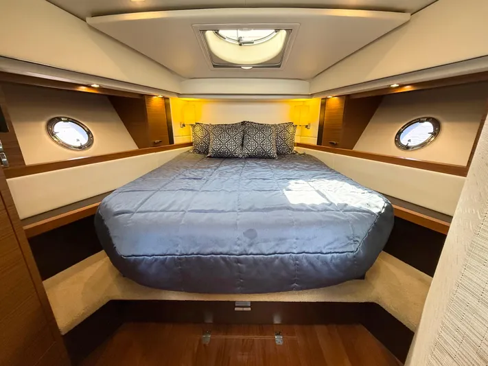 Silver Lining, Name Reserved Yacht Photos Pics Luxurious bedroom interior of 2017 Tiara Yachts 39 Coupe with elegant bedding and porthole windows.