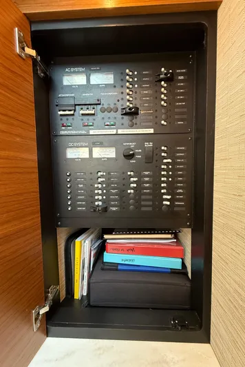 Silver Lining, Name Reserved Yacht Photos Pics Electrical panel inside 2017 Tiara Yachts 39 Coupe, featuring control switches and manuals.