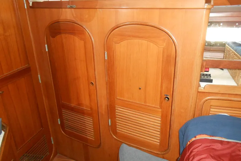 Second Kiss Yacht Photos Pics Wooden interior of 1989 Norseman 447 yacht with two arched cabinet doors.