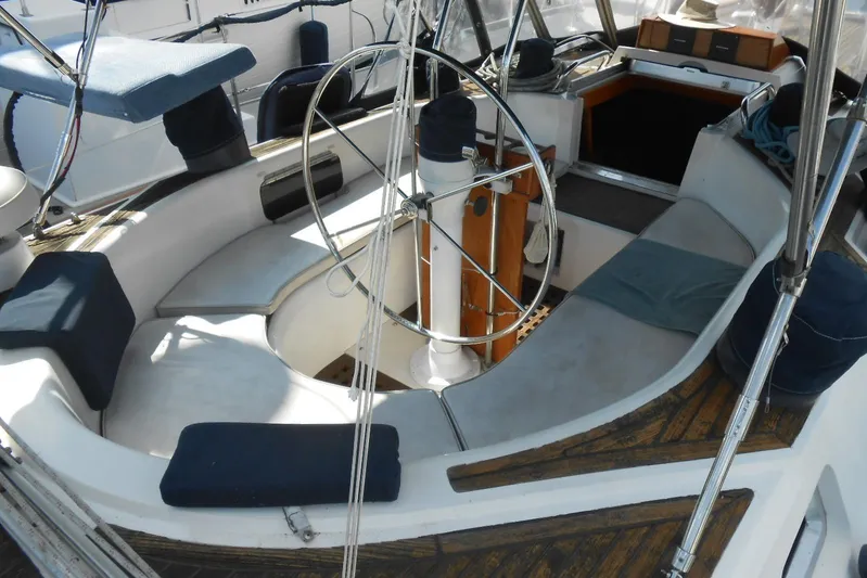 Second Kiss Yacht Photos Pics 1989 Norseman 447 sailboat cockpit with steering wheel and seating area.
