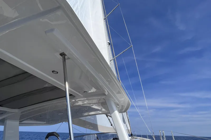  Yacht Photos Pics Sailing yacht Hanse 588, 2023 model, with sails against a clear blue sky.