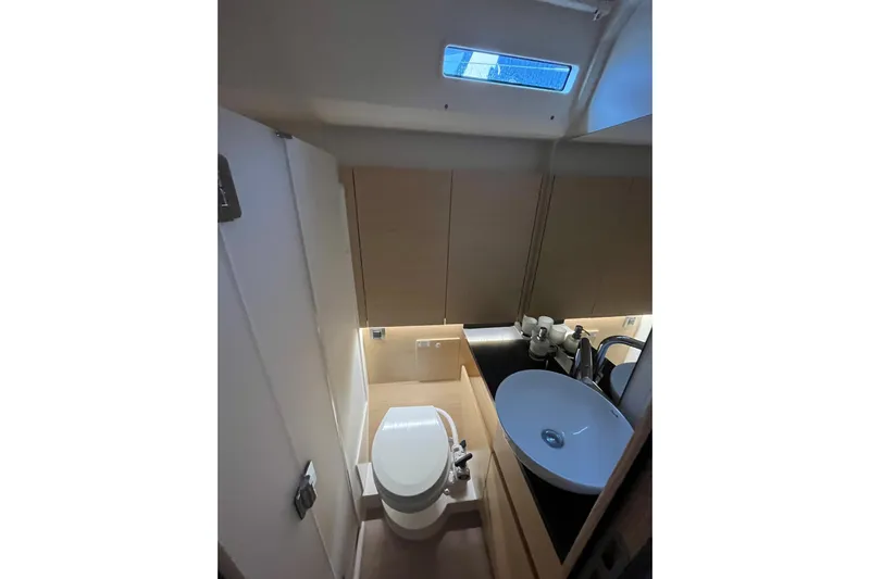  Yacht Photos Pics Modern bathroom interior of 2023 Hanse 588 yacht with sleek fixtures and compact design.