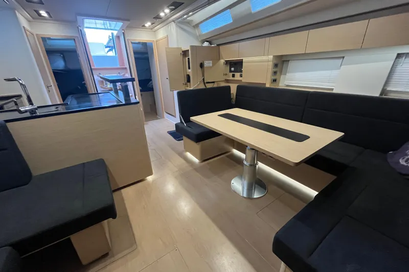  Yacht Photos Pics Interior of 2023 Hanse 588 yacht, featuring modern seating and dining area.