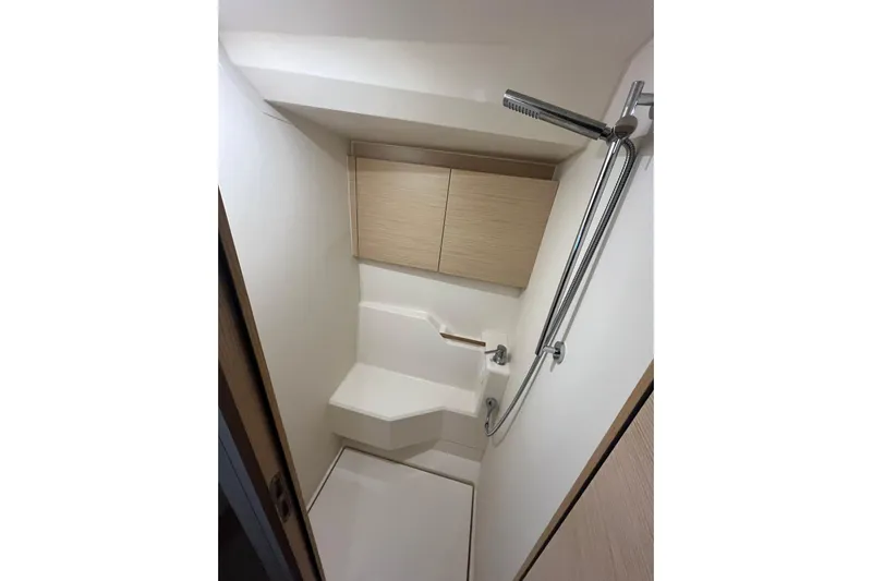  Yacht Photos Pics Compact bathroom in 2023 Hanse 588 yacht with modern shower and storage cabinets.