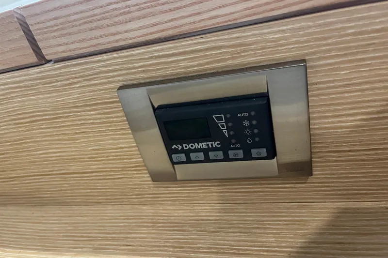  Yacht Photos Pics Dometic control panel on 2023 Hanse 588 yacht, mounted on wood paneling.