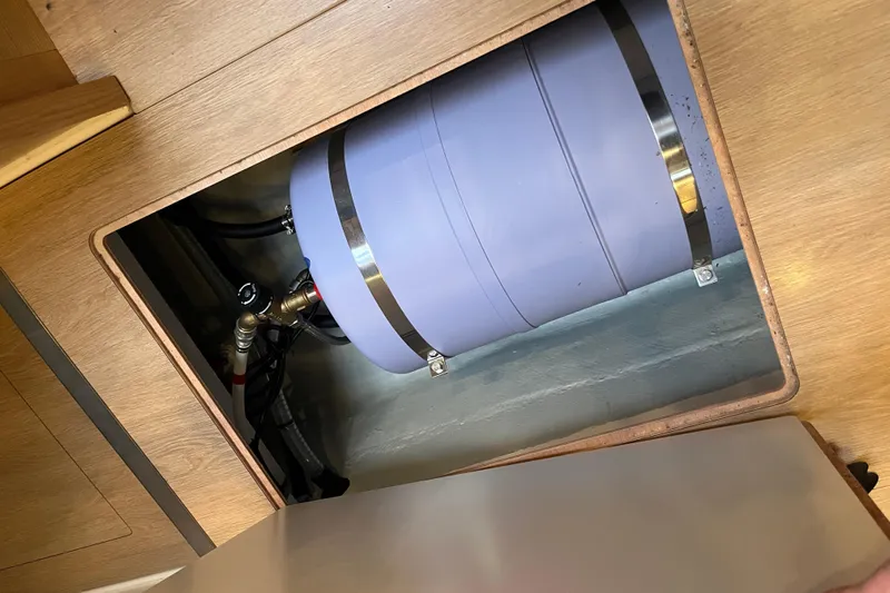  Yacht Photos Pics Underfloor compartment of 2023 Hanse 588 yacht showing a secured cylindrical tank.
