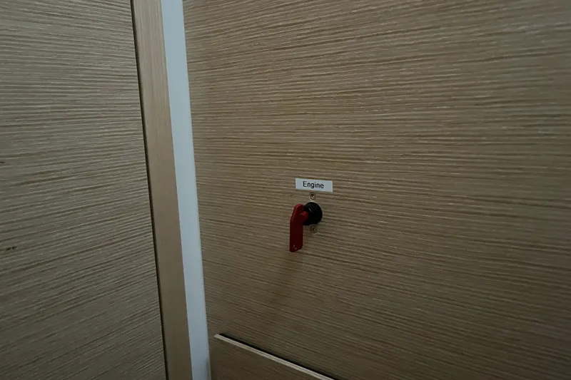  Yacht Photos Pics Red engine switch on wooden panel of 2023 Hanse 588 yacht.