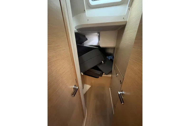  Yacht Photos Pics Narrow hallway inside 2023 Hanse 588 yacht with wooden doors and storage area.