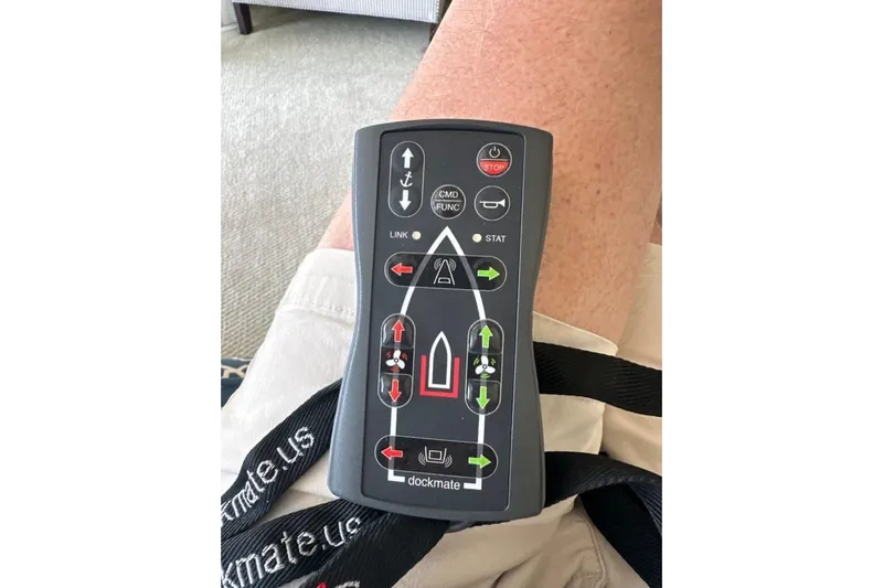 Prairie Sky Yacht Photos Pics Remote control for Ocean Alexander 48C Classicco yacht, 2008 model, on a person's lap.