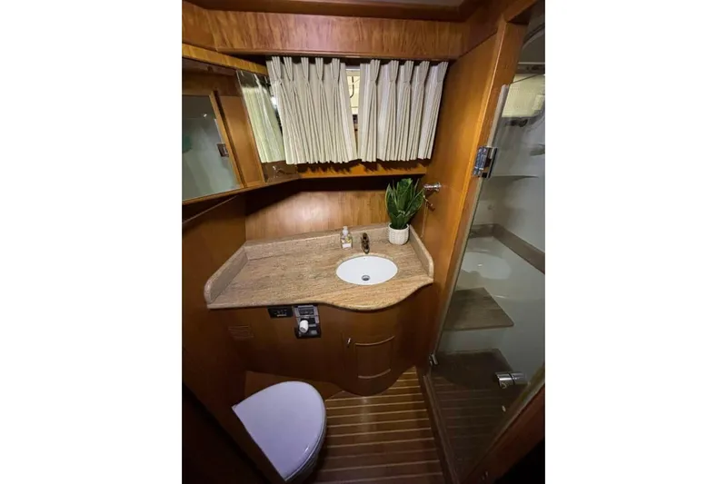 Prairie Sky Yacht Photos Pics Bathroom interior of 2008 Ocean Alexander 48C Classicco yacht, featuring wood accents and modern fixtures.