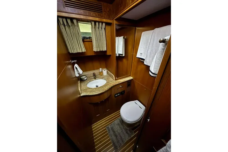 Prairie Sky Yacht Photos Pics Luxurious bathroom in 2008 Ocean Alexander 48C Classicco yacht with wood accents and modern amenities.