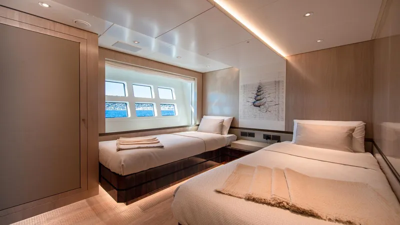 Oceanic 143 Yacht Photos Pics Luxurious cabin interior of 2023 Canados 143 yacht with twin beds and ocean view.