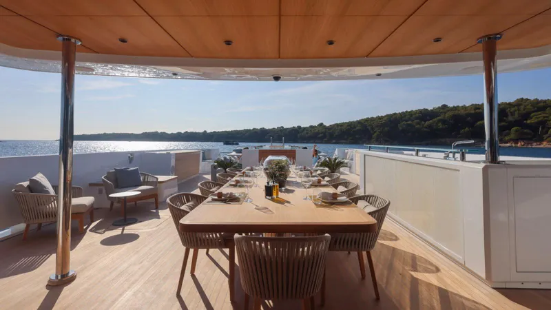 Oceanic 143 Yacht Photos Pics Luxurious dining area on 2023 Canados 143 yacht with ocean view.