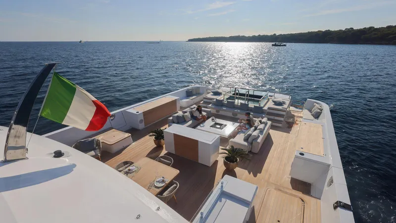 Oceanic 143 Yacht Photos Pics Luxury Canados 143 yacht deck with Italian flag, 2023 model, on serene ocean.