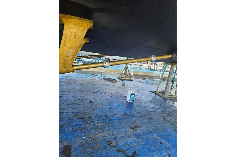 "fortunate" Yacht Photos Pics Underneath view of a 1995 JOHNSON 65 Flybridge Motoryacht on a blue tarp.