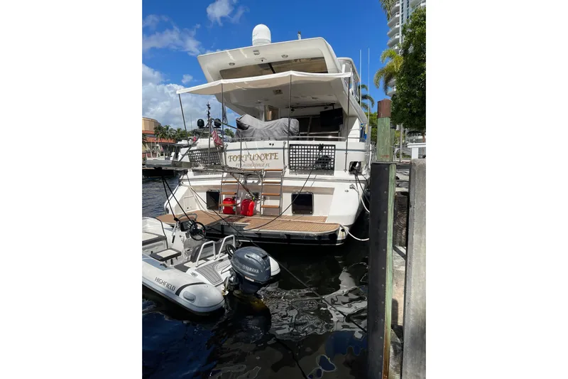 "fortunate" Yacht Photos Pics 1995 JOHNSON 65 Flybridge Motoryacht docked with inflatable boat attached.